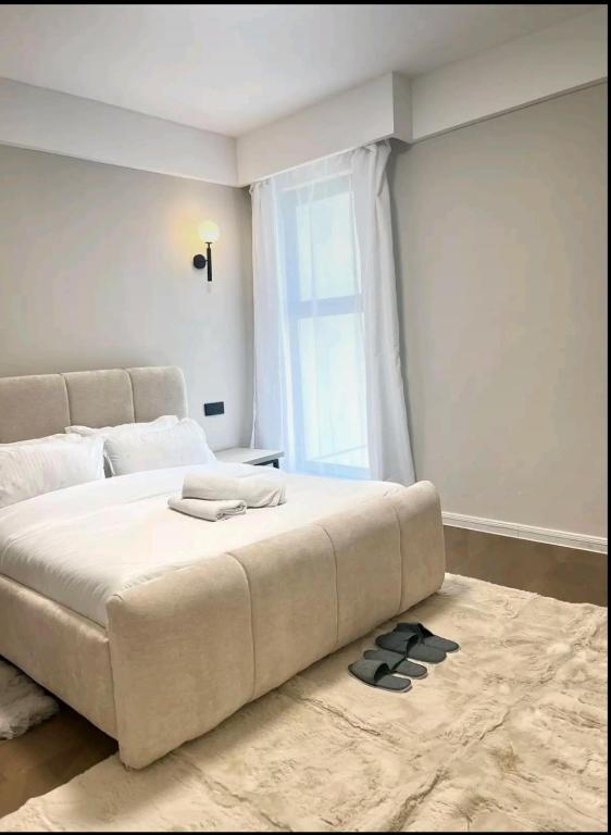 a large white bed in a room with a window at Luxore apartment in Syokimau