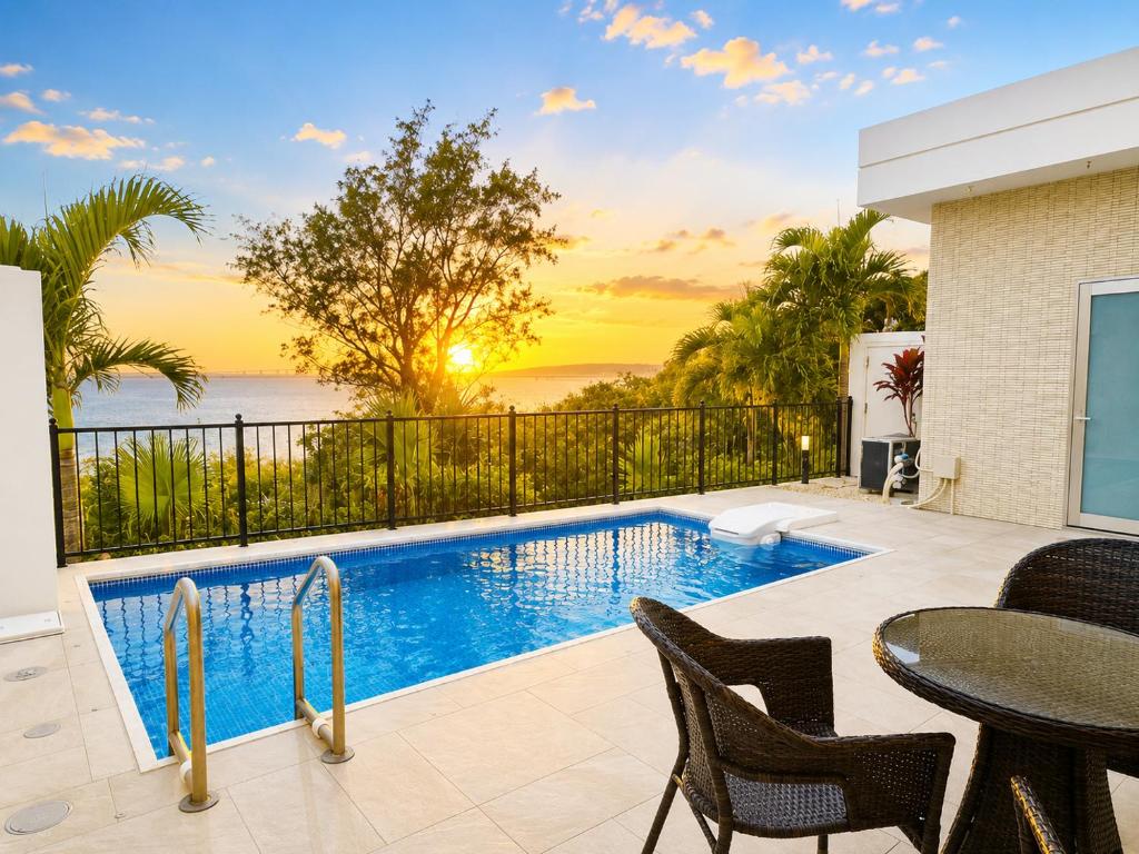 a patio with a pool and a table and chairs at -Villa Rikyu- 離宮 in Miyako-jima