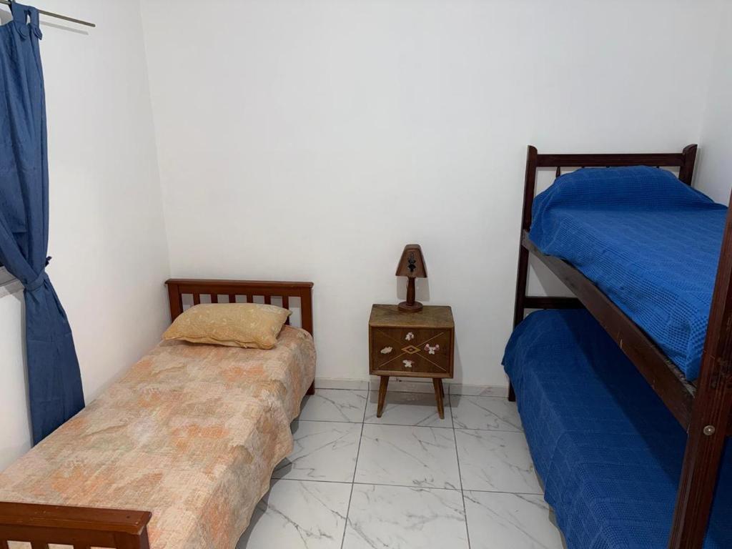 a bedroom with two bunk beds and a night stand at Runa Huasi in Tinogasta