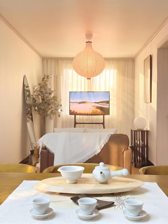 a living room with a table with bowls on it at Dazzlday in Seoul