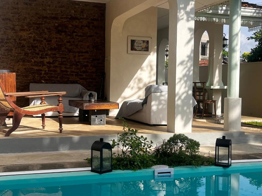 a house with a swimming pool and a patio at BnB by Month in Weligama