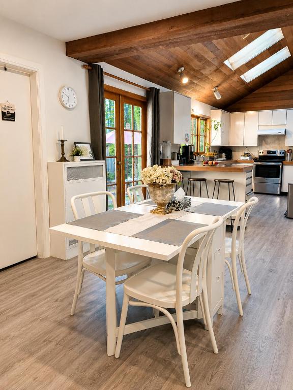 a kitchen with a table and chairs in a room at Evergreen House in Vancouver