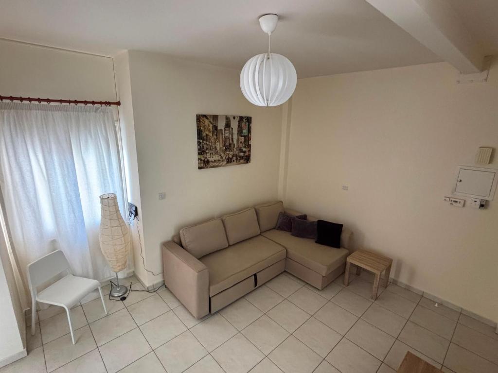 a living room with a couch and a chair at Theodorou Town Residence in Strovolos
