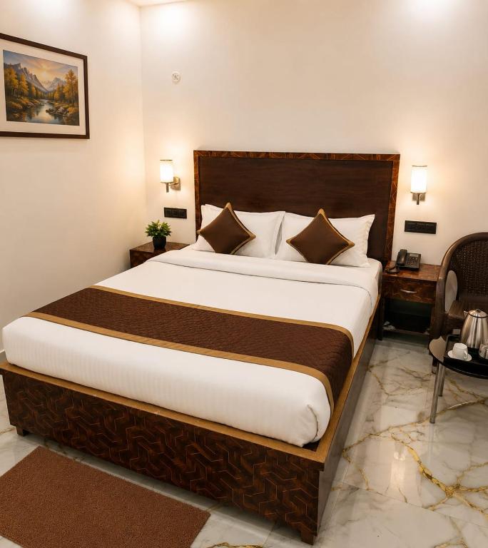 a bedroom with a large bed in a room at HOTEL SAMAY Rajgir in Rājgīr