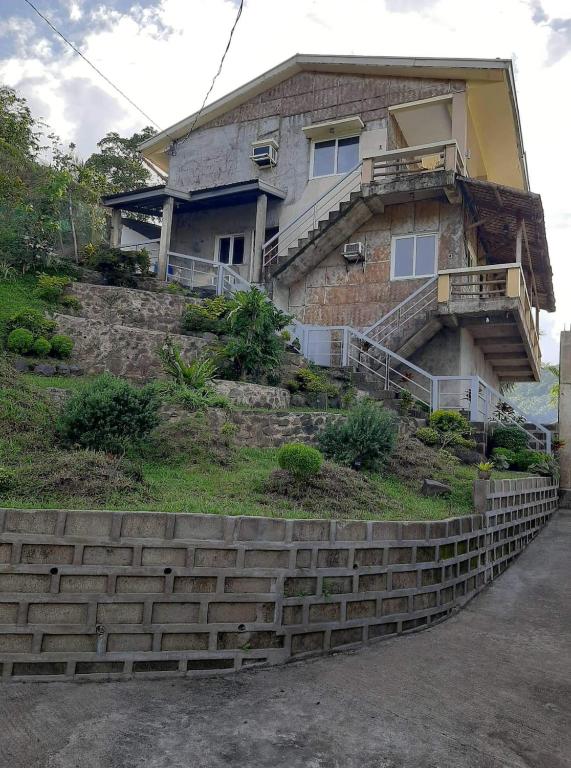 a house on a hill with steps in front of it at Mamima BnB in Caramoan