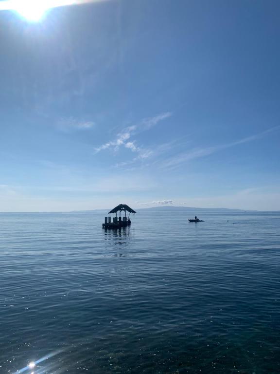 a boat in the middle of the water at Dumaguete Dive Center in Mojon