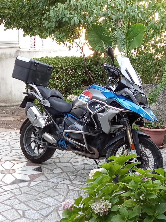 a blue and black motorcycle parked on a sidewalk at HOLIDAY ROOM - THE VIEW in Novi Vinodolski