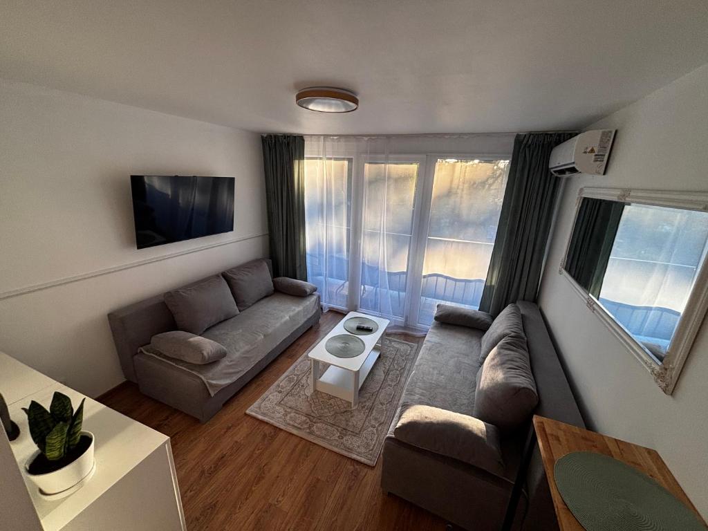 a living room with a couch and a table at SANSET APART Okuninka in Okuninka