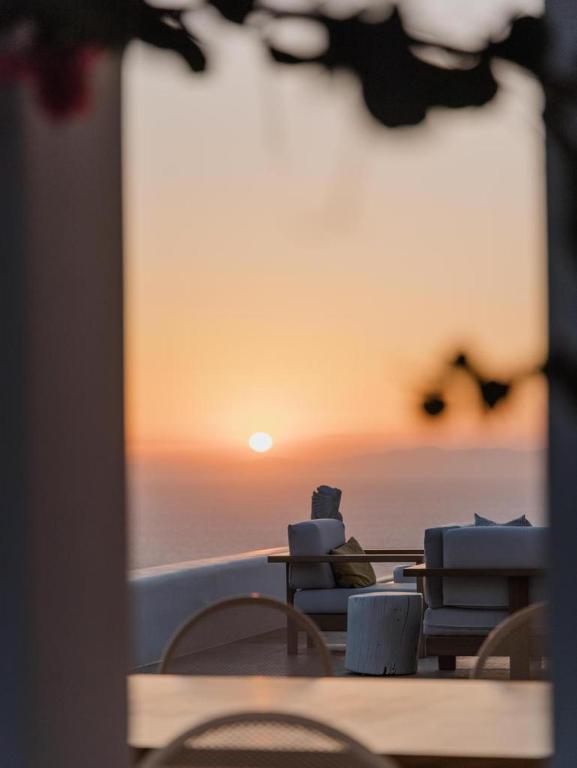 a table and chairs with a view of the ocean at Sotavento Villa in Fanari