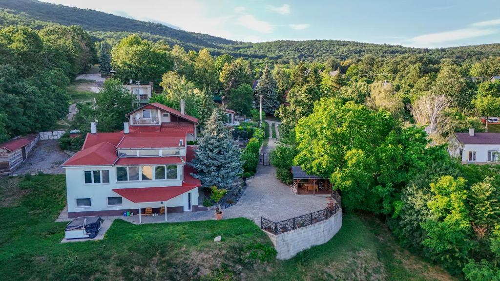 an aerial view of a house with a red roof at Riverside Forest Prestige in Chlʼaba