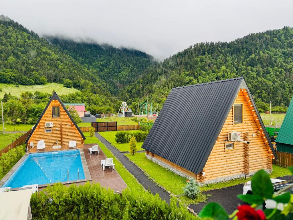 an aerial view of a home with a swimming pool at Eco cottage in Borjomi with pool 2 in Sadgeri