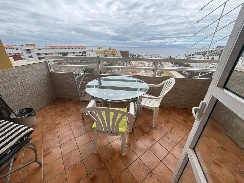 a table and chairs on a balcony with a view at Orlando Costa Adeje in Adeje