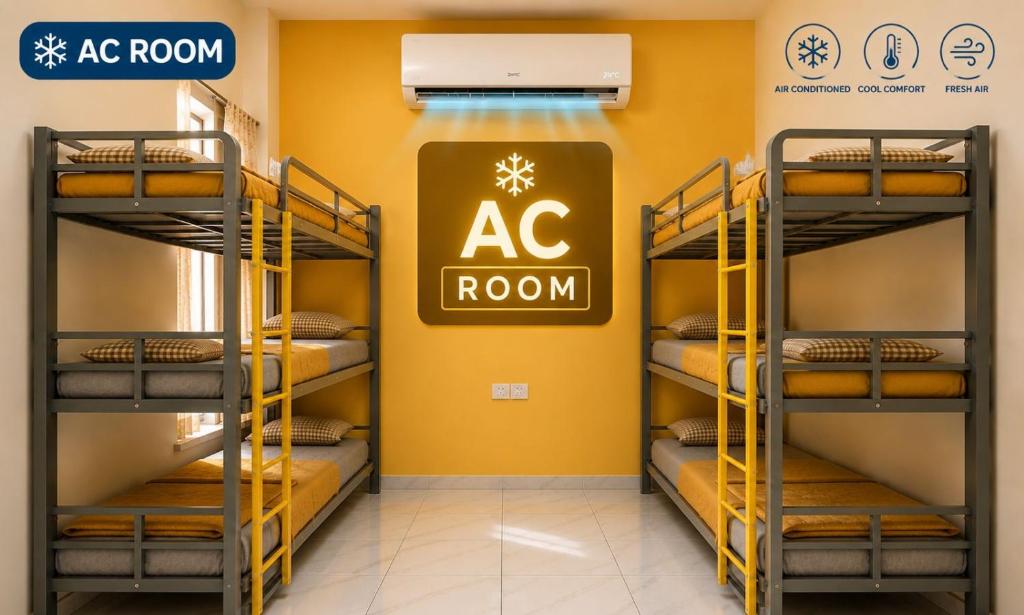 a room with bunk beds with a ac room sign on the wall at Homies Homestay Boys Hostel in Kurukshetra