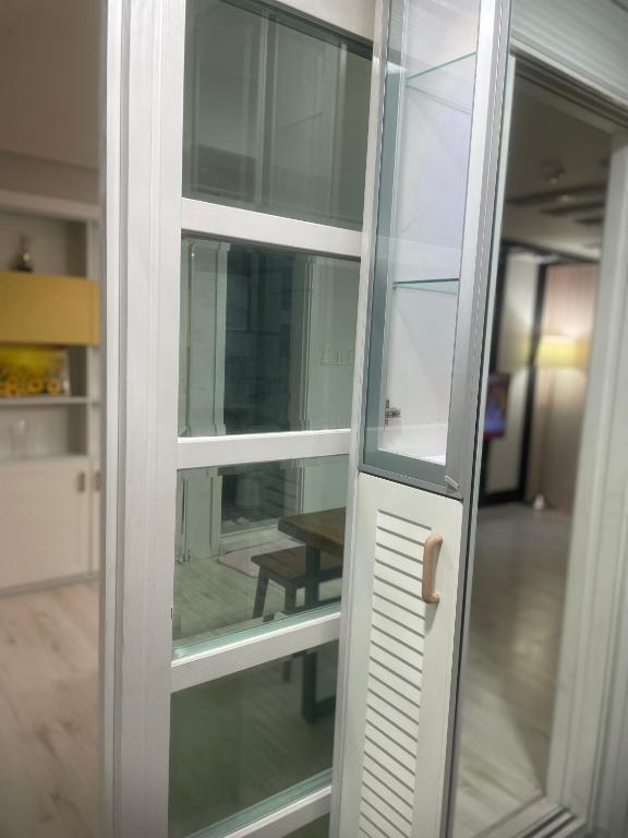 a glass door with a reflection of a table at 행운외국인여성전용게스트하우스 in Pup'yŏng-yŏk