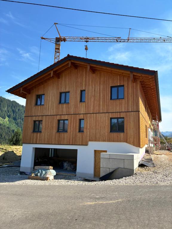 a house being constructed with a crane on top at Ferienhof Haug in Bad Hindelang