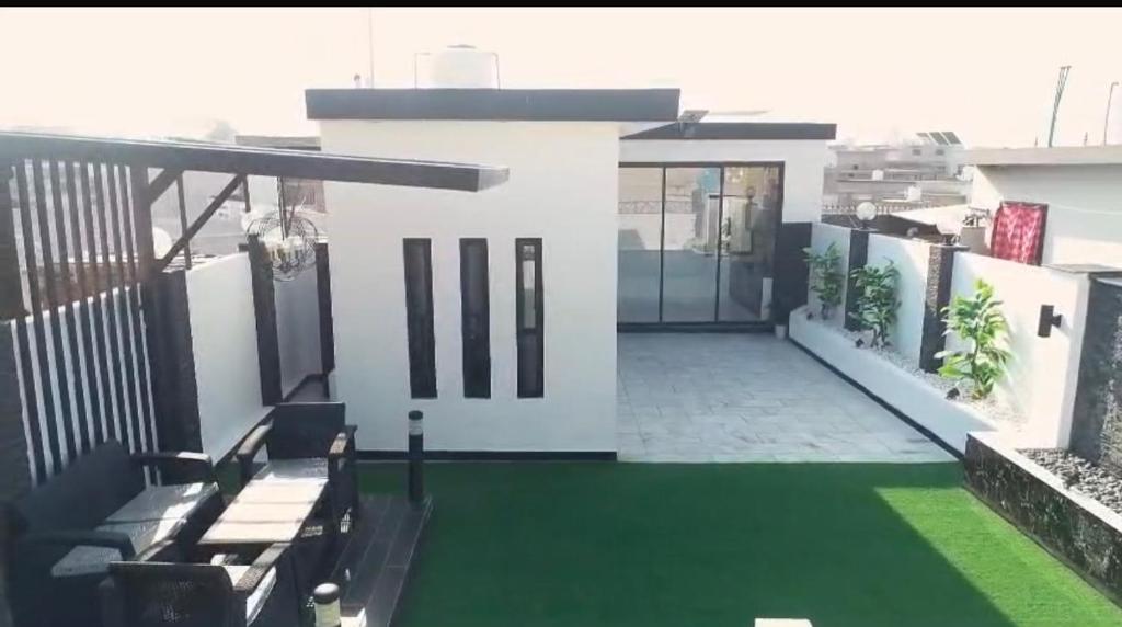 a view of a house with a green lawn at Meria town attock in Attock