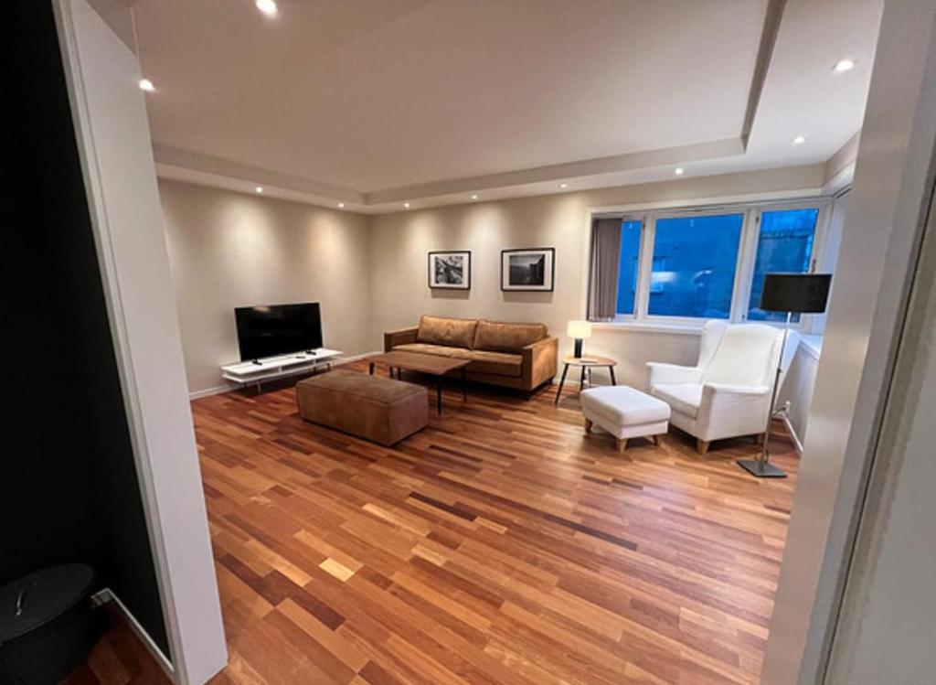 a living room with a couch and a tv at Apartment close to city center in Haugesund