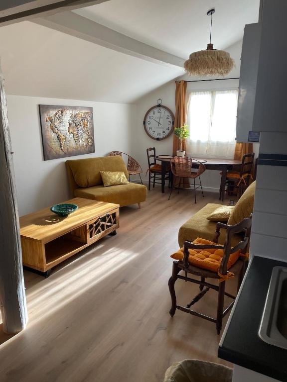 a living room with a couch and a table at Appartement in Arles