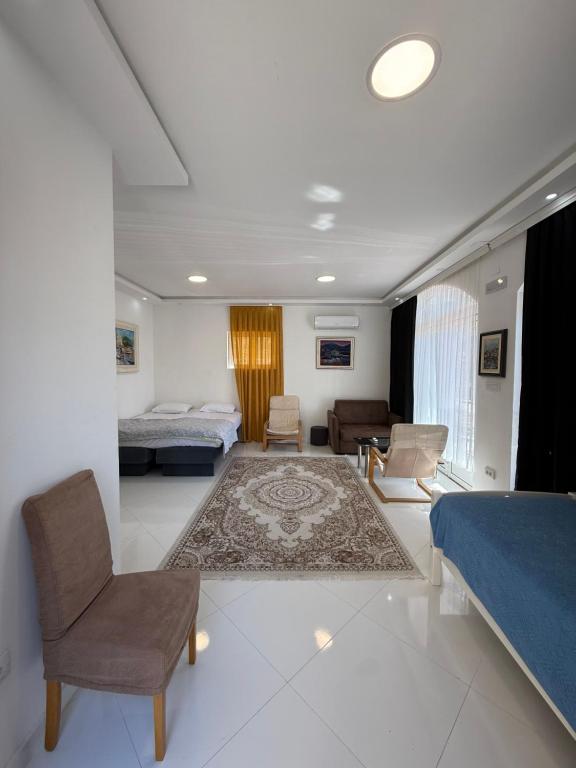 a bedroom with a bed and a living room at Vengo Apartments in Kotor
