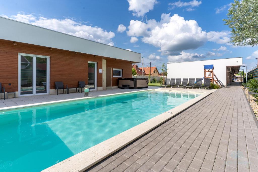 a swimming pool in the backyard of a house at Aqua Rosa Tiszafüred 2 in Tiszafüred