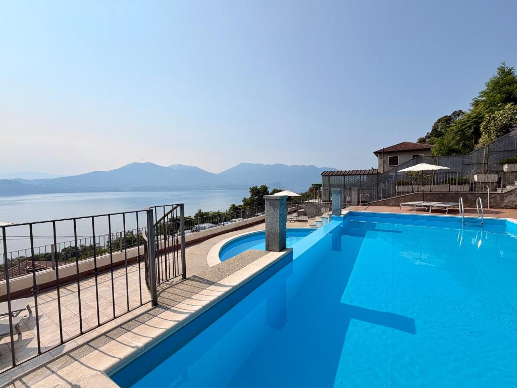 a swimming pool with a view of the water at Lakeview Residence in Oggebbio