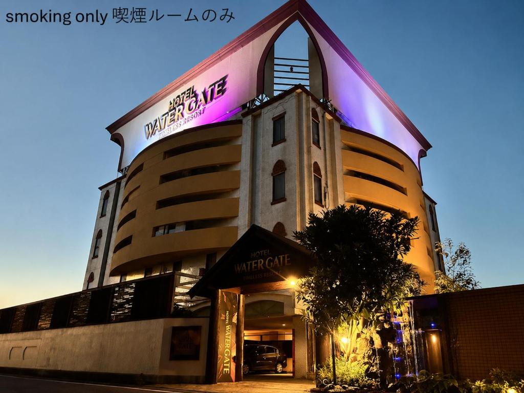 a hotel building with a sign on the side of it at ホテル-ウォーターゲート-岐阜-大人用- in Gifu