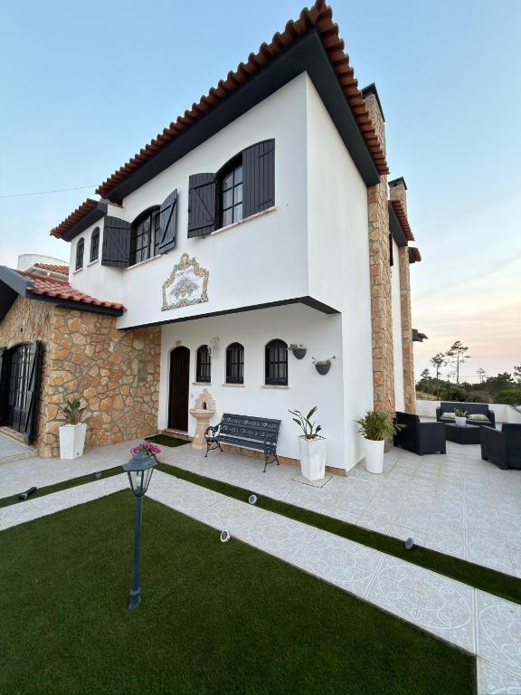 a view of a house with a yard at Lucas Residence in Nazaré