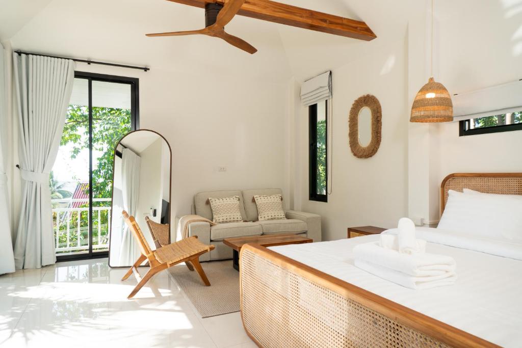a bedroom with a bed and a living room at Blue Sky Seaview in Haad Yao