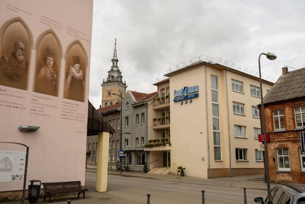 an empty street in a city with buildings at Šiaurės Vartai in Joniškis