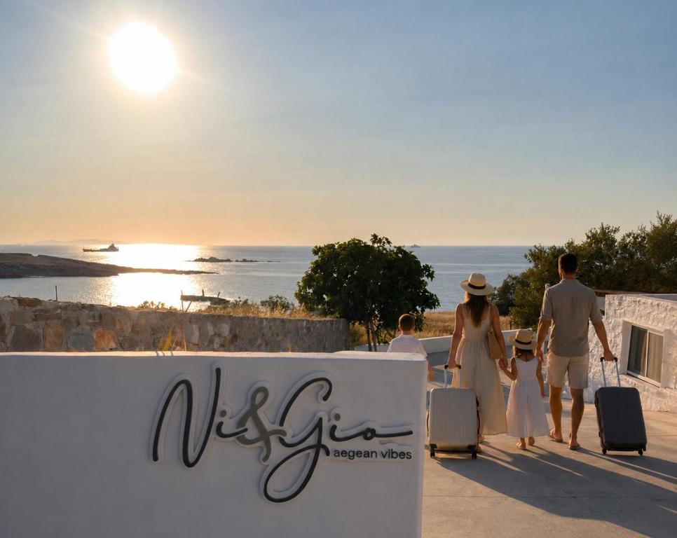 a group of people walking with their luggage near the ocean at Ni&Gio Sterna 6 in Parikia