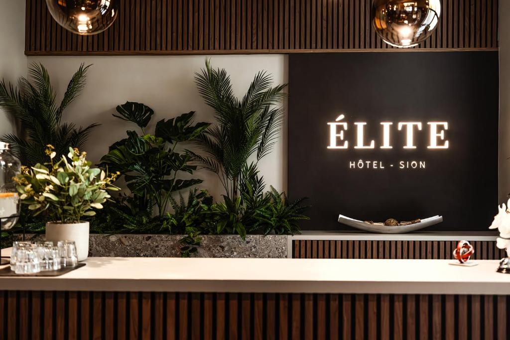 a bar in a hotel with plants on the wall at Hôtel Elite in Sion