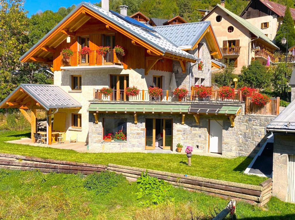 a large house with flowers on the front of it at Lamartine in Valloire