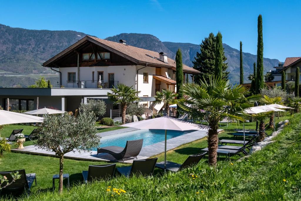 a villa with a swimming pool and a resort at Premium Apartments Faselehof in Marlengo