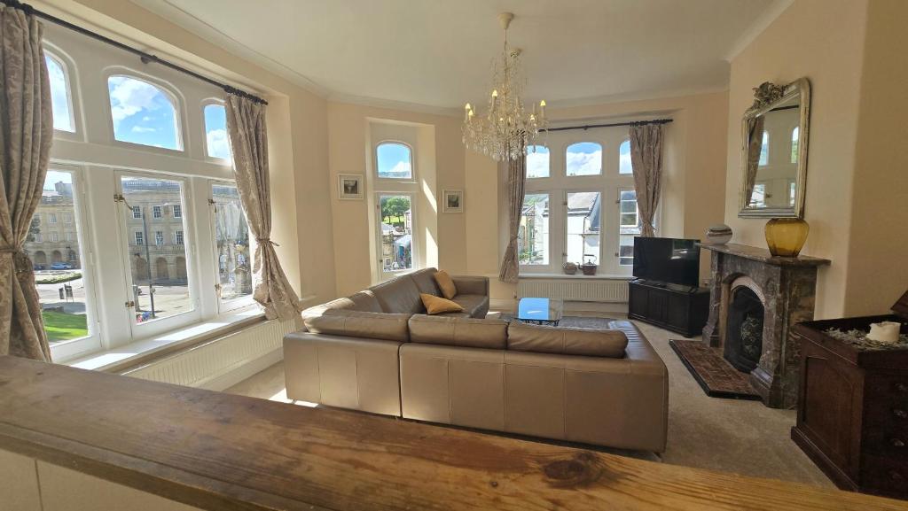 a living room with a couch and a fireplace at Palace View Apartment in Buxton