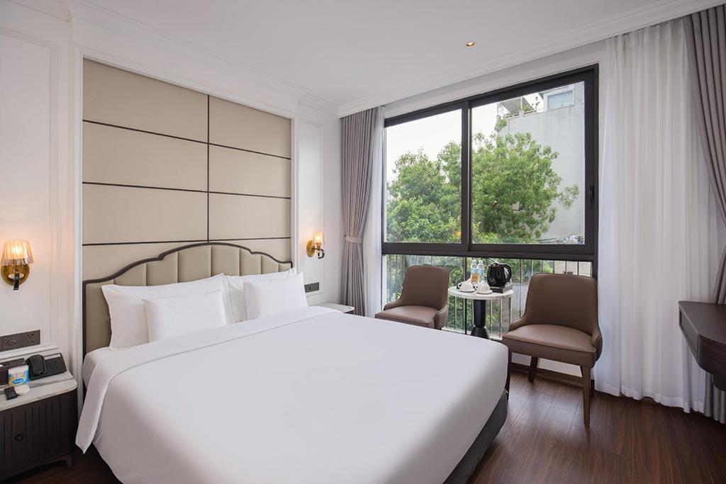 a bedroom with a large bed and a large window at A25 - Premium Hotel - 95 Lò Đúc in Hanoi