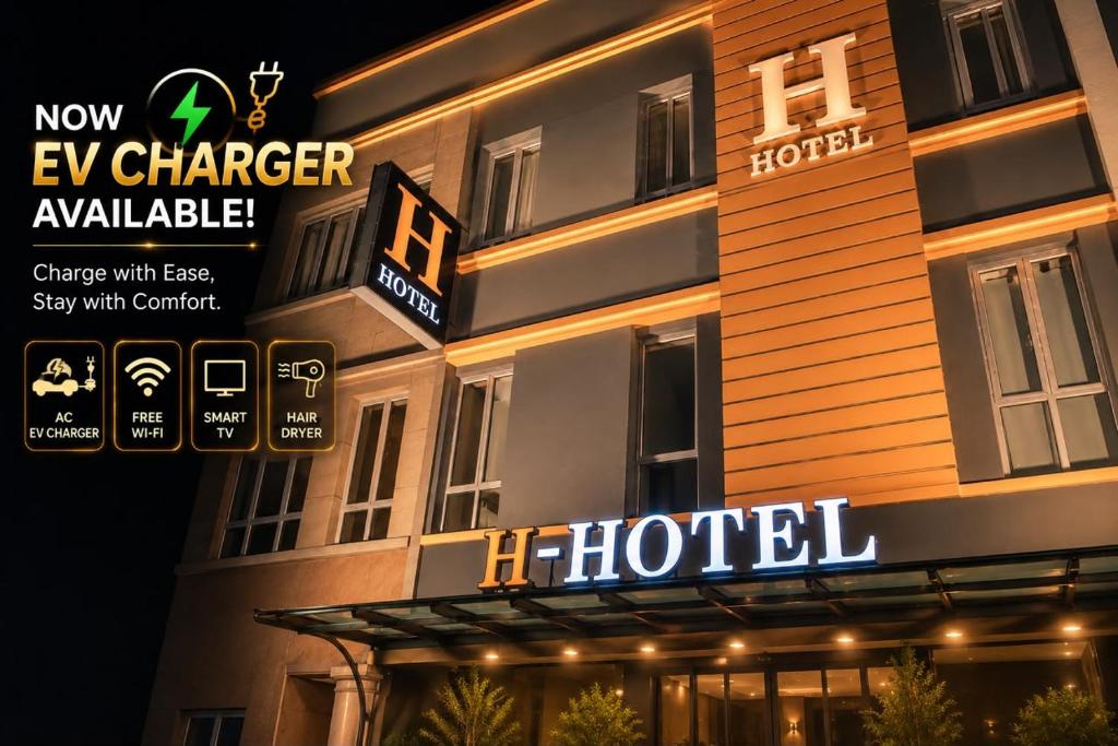 a hotel building with a hotel sign in front of it at H Hotel in Segamat