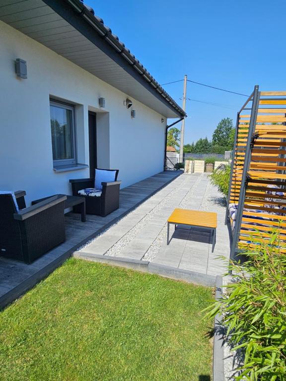 a patio with a yellow bench and a house at Jaworze in Jaworze