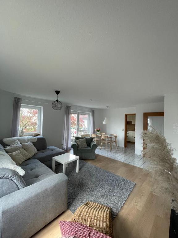 a living room with a couch and a table at schöne Ferienwohnung in Meckenbeuren