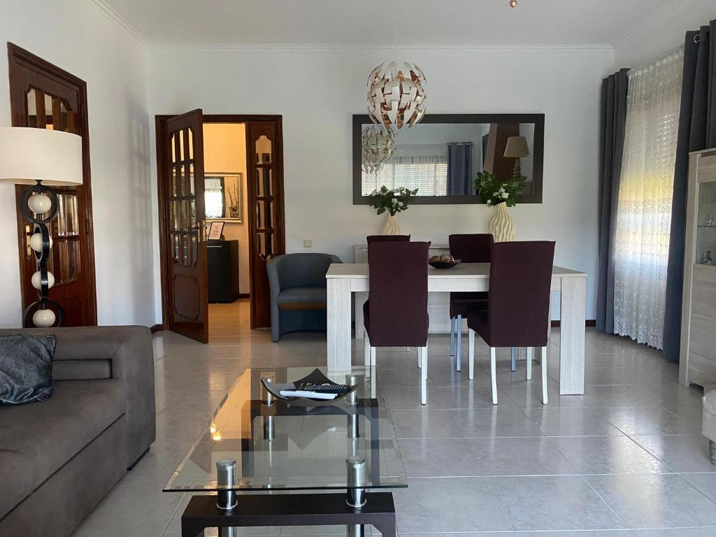 a living room with a table and a couch at Casa Boa Nova Valadares in Valadares