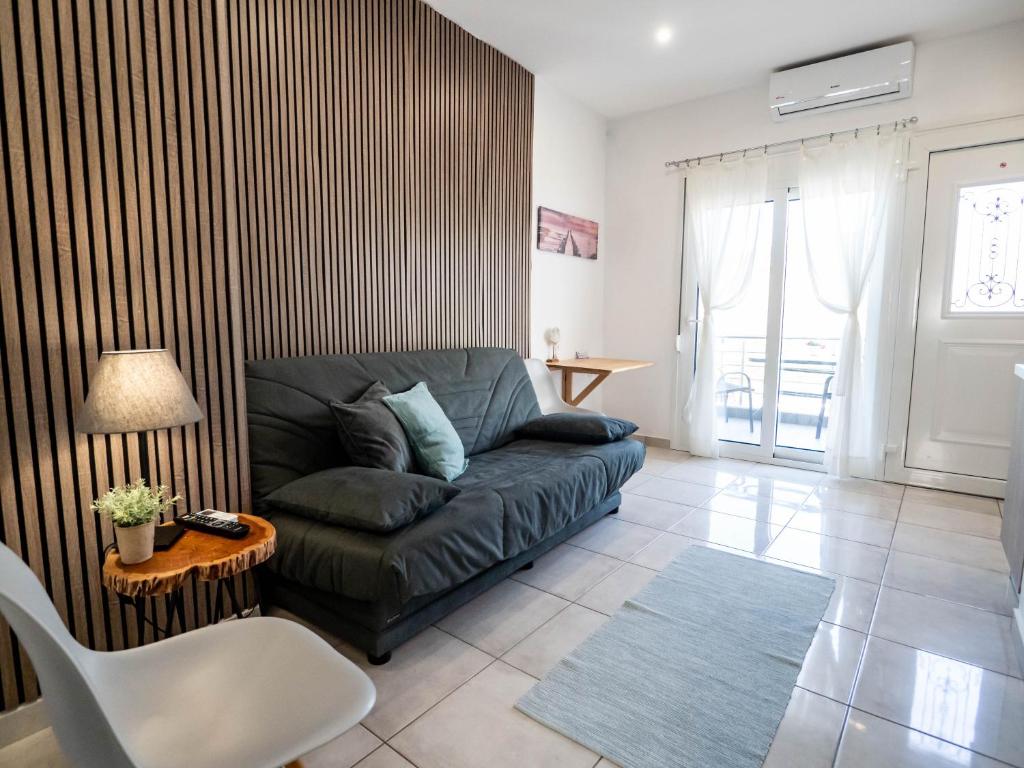 a living room with a couch and a table at Doukas Apartments & Studios in Skala Marion