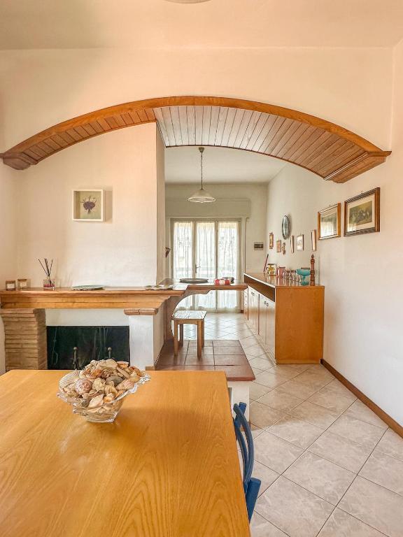 a kitchen and living room with a table and a fireplace at Lido di Camaiore-Spacious & Bright 2Bedrooms House in Lido di Camaiore