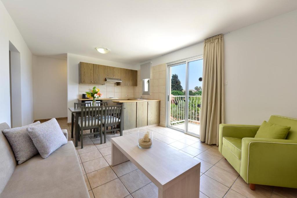 a living room with a couch and a table at Makronisos Village in Ayia Napa