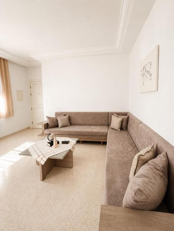 a living room with a couch and a coffee table at Superb apartment Monastir in Monastir