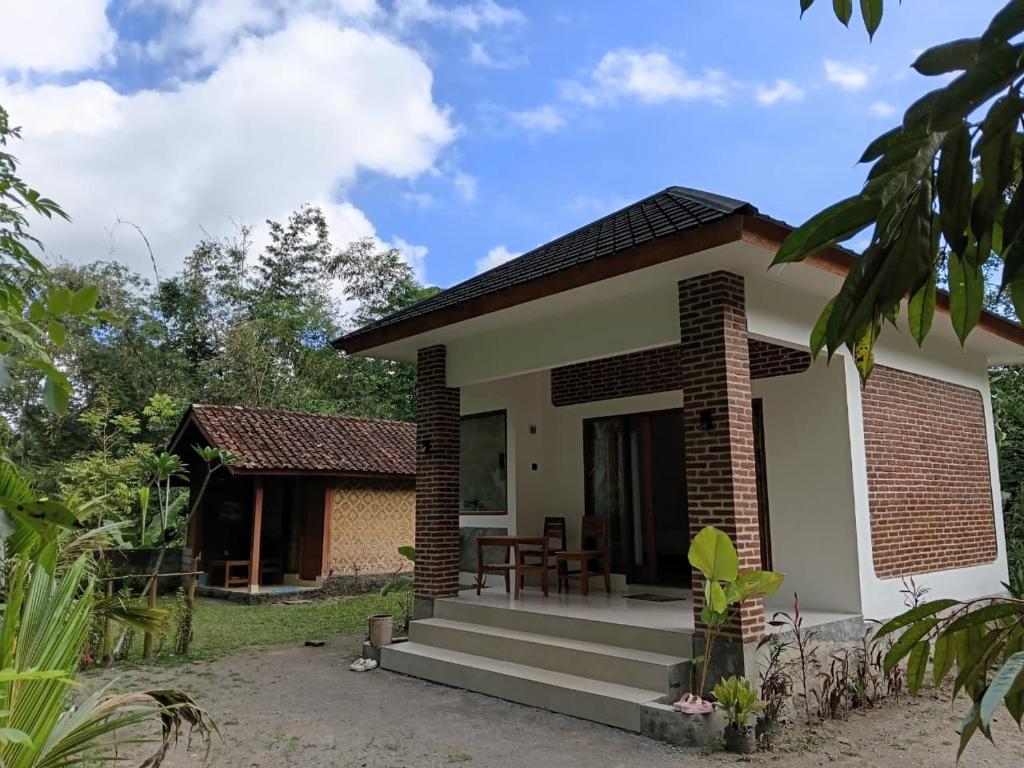 a small house with a porch at Tereng Wilis Jungle Inn in Tetebatu