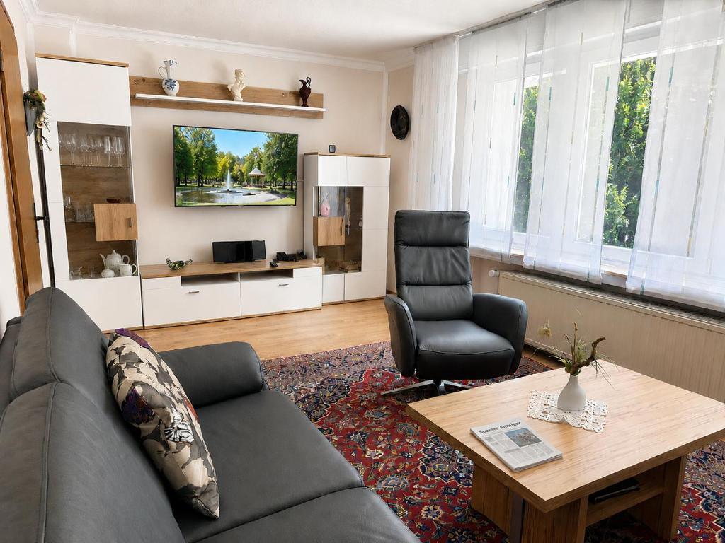 a living room with a couch and a table at Haus Sigge Ferienwohnungen in Bad Sassendorf