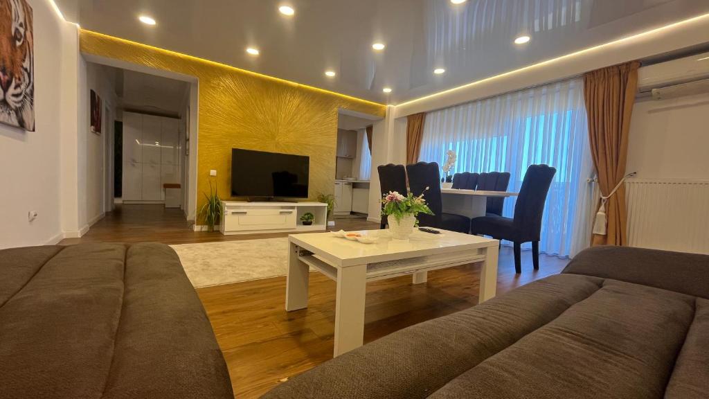 a living room with a couch and a table at ZBI Apartament in Oradea