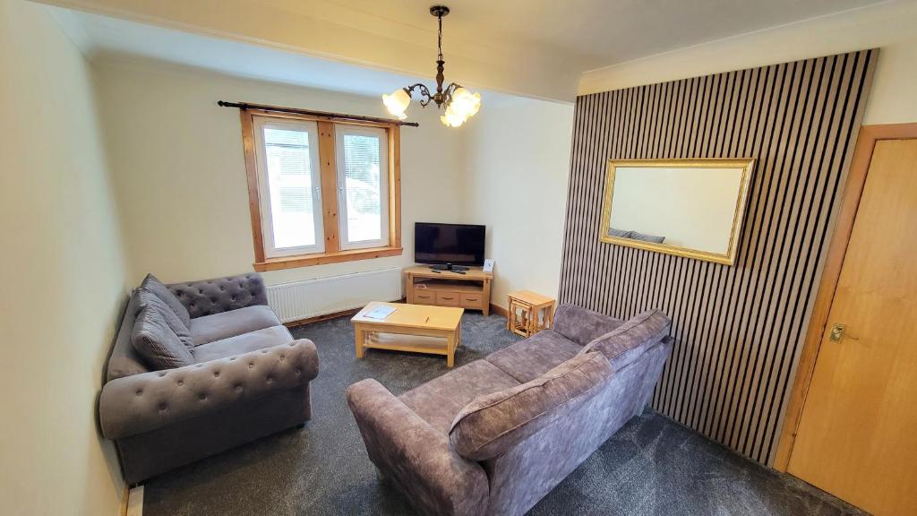 a living room with two couches and a television at Stornoway Stays Apartment in Stornoway