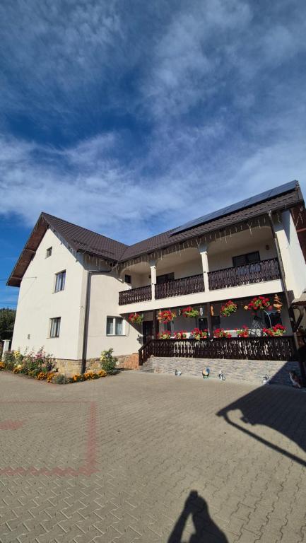 a person standing in front of a building at Piatra Humorului in Mănăstirea Humorului