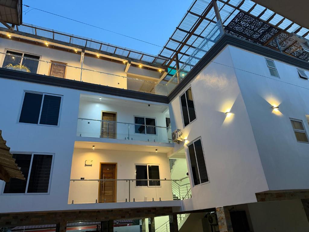 a large white building with a glass roof at Bonsukoda Lodge in Accra