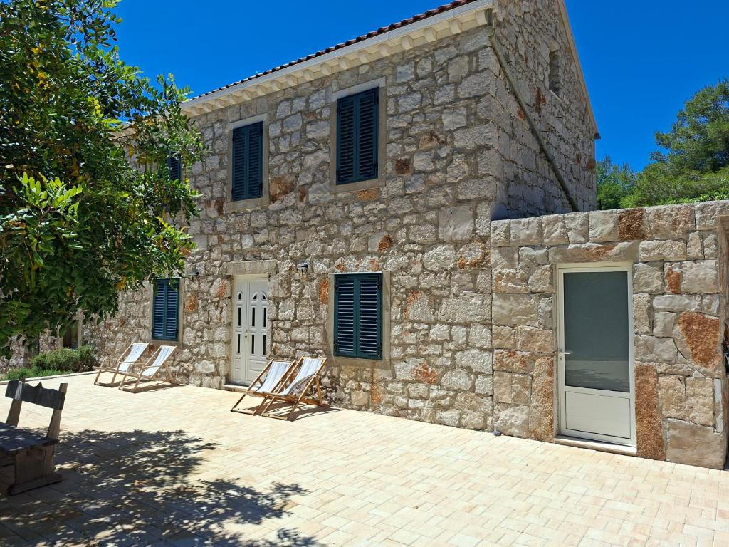 a group of chairs sitting outside of a stone building at House Antica in Lastovo